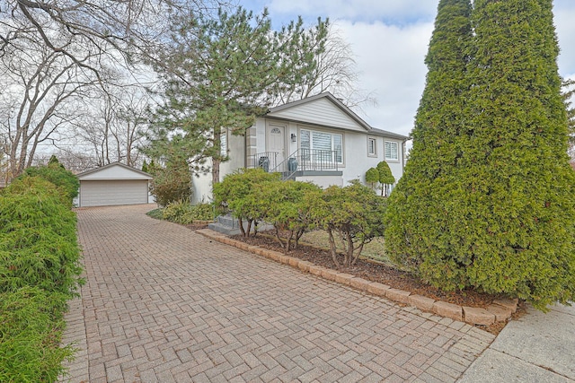 view of front of home with an outbuilding, a detached garage, and stucco siding