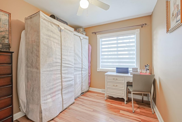 office area featuring light wood-style floors, ceiling fan, and baseboards