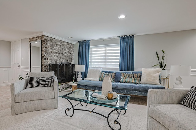 living room featuring a wainscoted wall, recessed lighting, a decorative wall, a brick fireplace, and carpet flooring