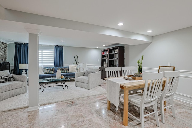 dining room featuring recessed lighting, marble finish floor, and a wainscoted wall