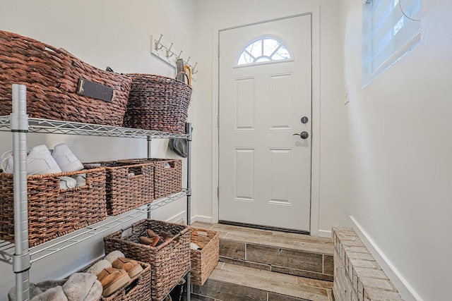 interior space featuring baseboards and wood tiled floor