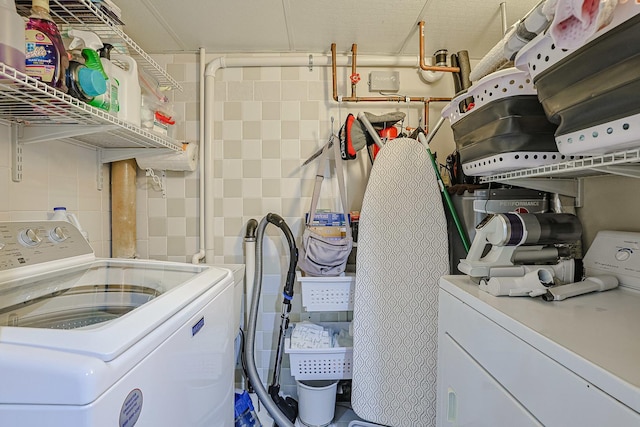 washroom with laundry area and washer and dryer