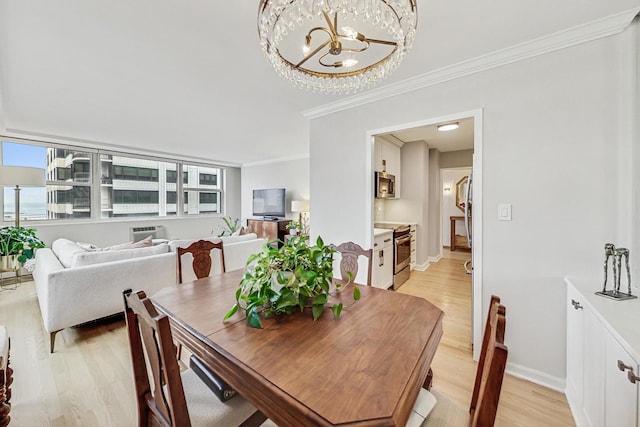 dining space with ornamental molding, a notable chandelier, and light hardwood / wood-style floors