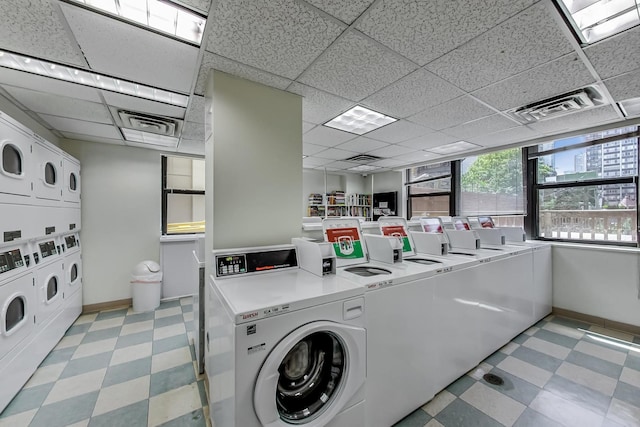 laundry room with stacked washer and dryer and separate washer and dryer