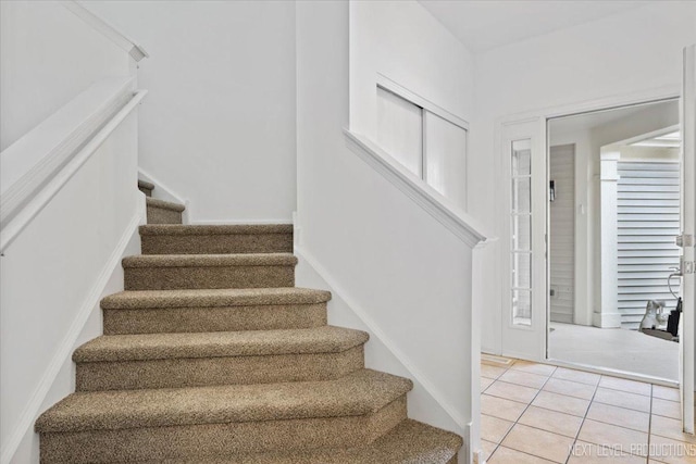 stairway featuring tile patterned flooring