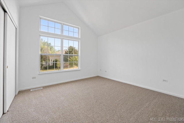 interior space with high vaulted ceiling and carpet