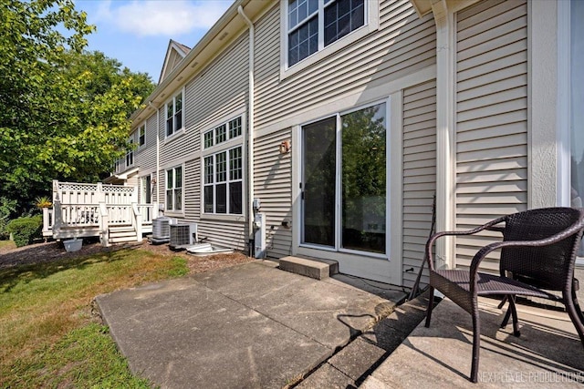 exterior space featuring cooling unit and a deck