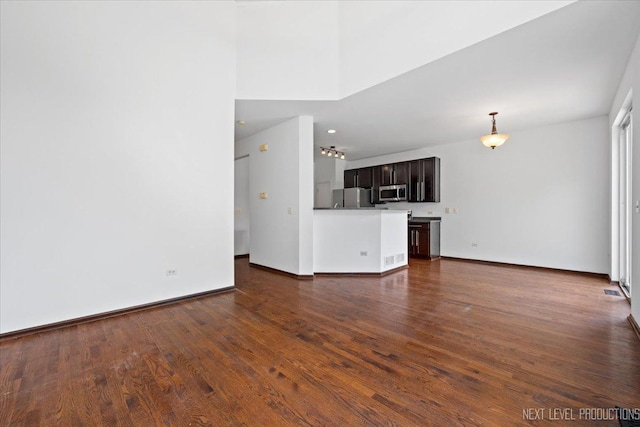 unfurnished living room featuring dark wood-type flooring