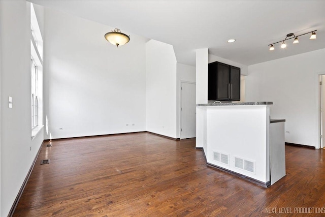 unfurnished living room featuring dark wood-type flooring