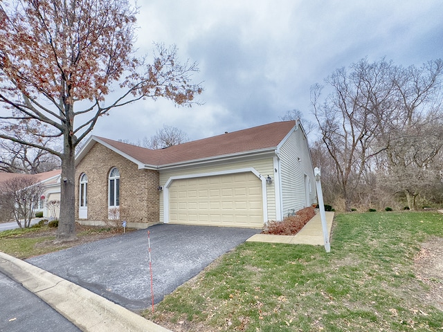 view of side of home with a yard and a garage