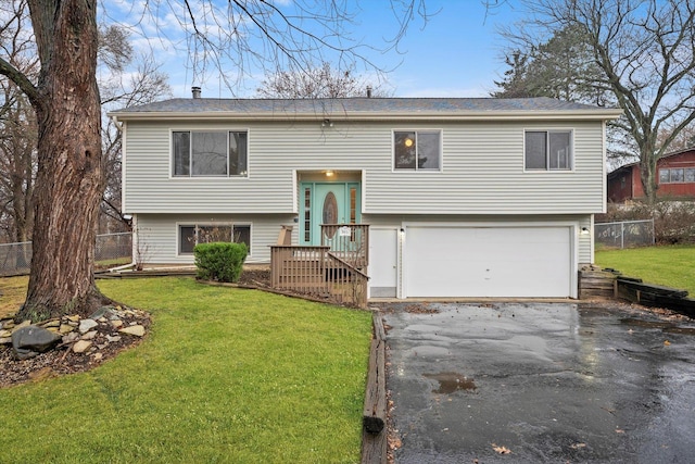 raised ranch with a front yard and a garage