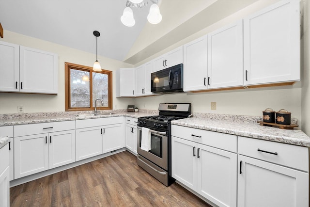 kitchen featuring stainless steel gas stove, white cabinets, pendant lighting, and dark hardwood / wood-style floors