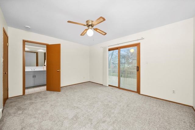 unfurnished bedroom featuring light carpet, access to exterior, ceiling fan, sink, and connected bathroom