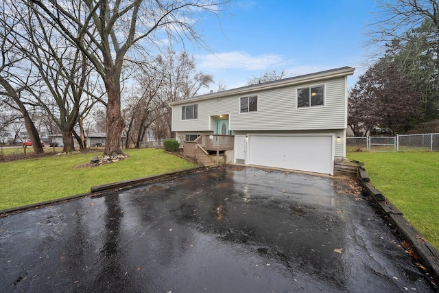 split foyer home with a front lawn and a garage