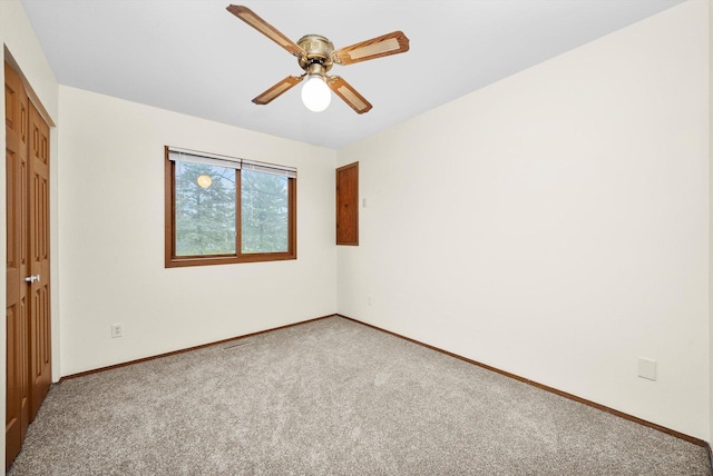 empty room featuring carpet flooring and ceiling fan