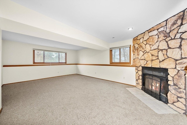 unfurnished living room featuring light carpet and a fireplace