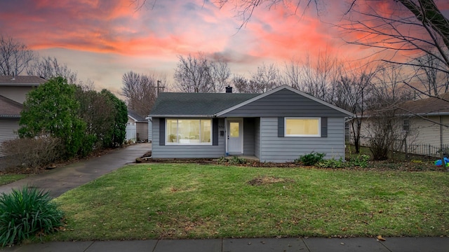 ranch-style house with a lawn