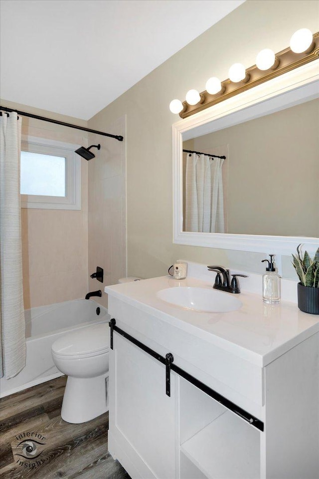 full bathroom with shower / tub combo with curtain, vanity, wood-type flooring, and toilet