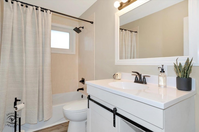 full bathroom with vanity, hardwood / wood-style floors, shower / bathtub combination with curtain, and toilet