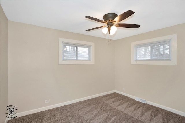 carpeted spare room featuring ceiling fan