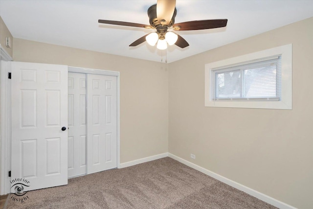 unfurnished bedroom with ceiling fan, carpet floors, and a closet