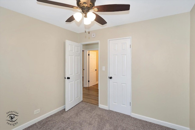 unfurnished bedroom with light colored carpet and ceiling fan