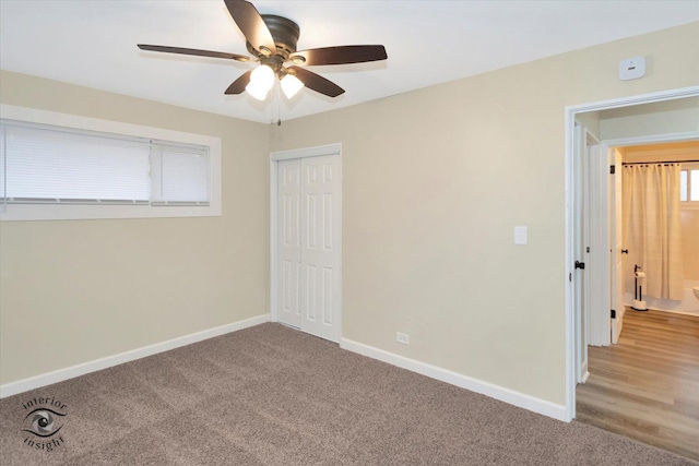 carpeted empty room with ceiling fan