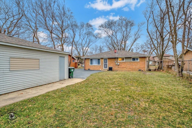 rear view of property with cooling unit and a lawn