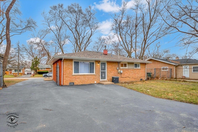 view of front of house featuring a front yard and central air condition unit