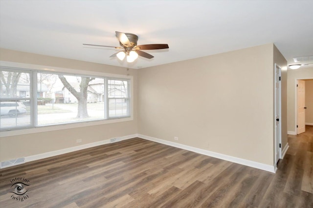 unfurnished room with a healthy amount of sunlight, dark wood-type flooring, and ceiling fan