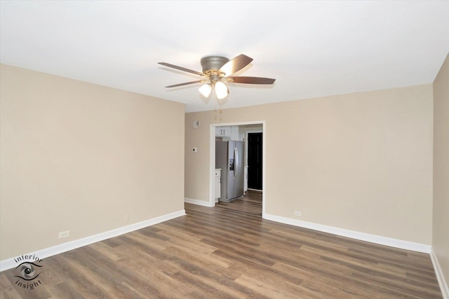 unfurnished room with dark hardwood / wood-style floors and ceiling fan