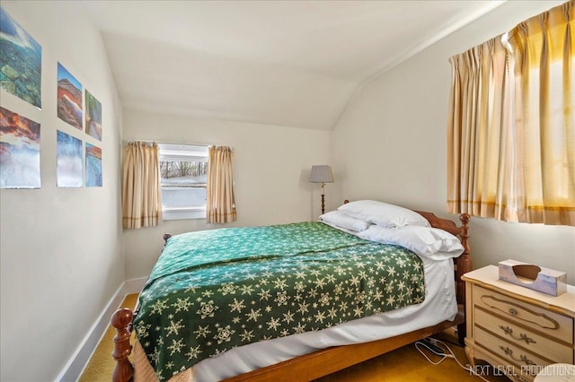 bedroom featuring carpet flooring and vaulted ceiling