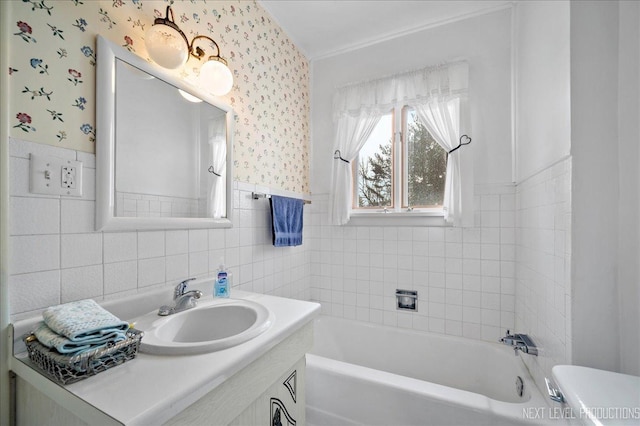 bathroom with a washtub, toilet, tile walls, and vanity