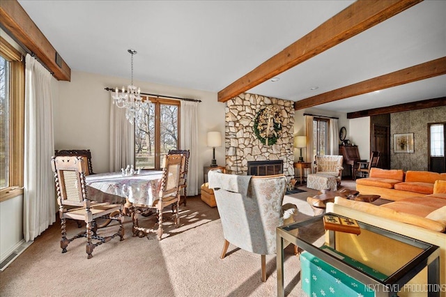 carpeted dining space featuring a fireplace, beam ceiling, and an inviting chandelier