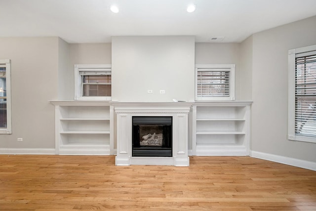 unfurnished living room featuring light wood-type flooring