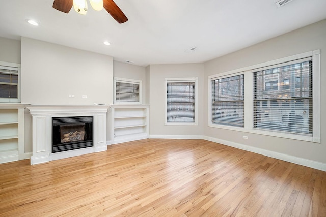 unfurnished living room with light hardwood / wood-style floors and ceiling fan