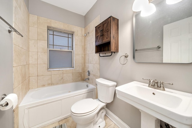 full bathroom featuring tiled shower / bath, sink, tile patterned floors, and toilet