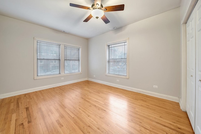 unfurnished bedroom featuring light wood-type flooring, ceiling fan, and a closet