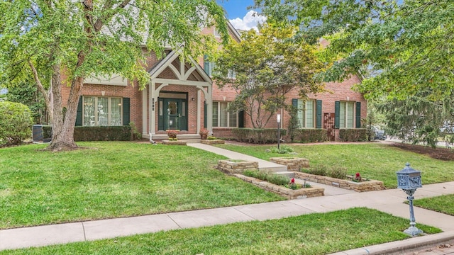 view of front of property featuring a front yard and central air condition unit