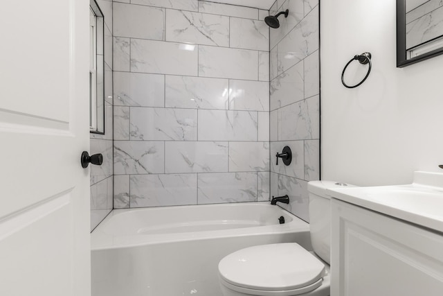 full bathroom with toilet, vanity, and tiled shower / bath