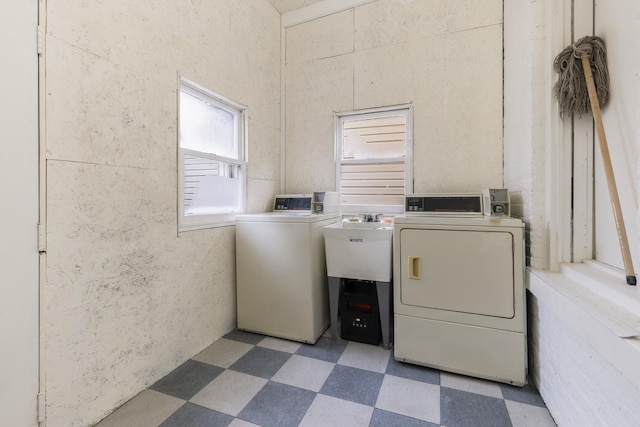 clothes washing area featuring washer and dryer and sink