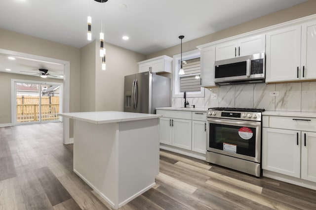 kitchen featuring white cabinetry, pendant lighting, and stainless steel appliances