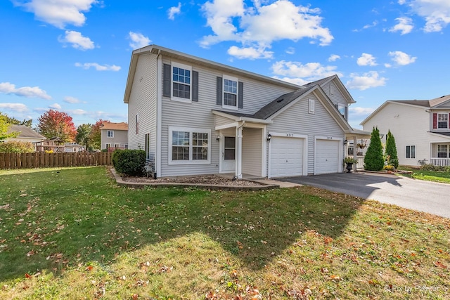 front of property featuring a front lawn and a garage