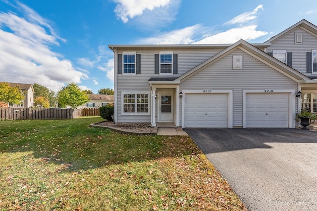 front facade featuring a garage and a front lawn