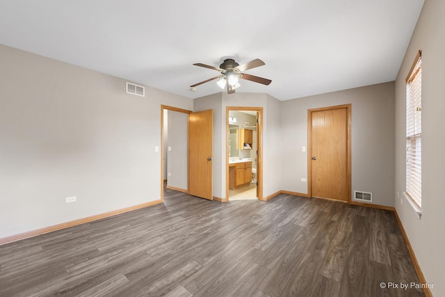 unfurnished bedroom featuring hardwood / wood-style flooring, ceiling fan, and connected bathroom