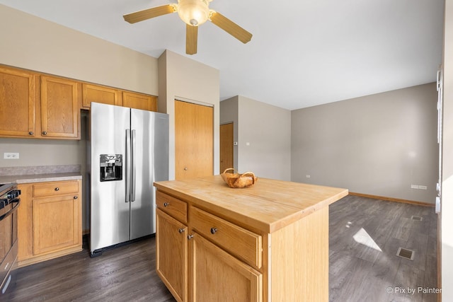 kitchen with butcher block counters, a kitchen island, dark hardwood / wood-style floors, and appliances with stainless steel finishes