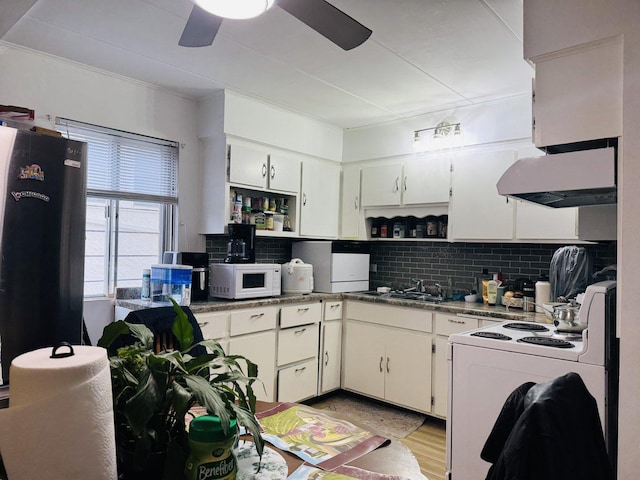 kitchen featuring white appliances, white cabinets, light hardwood / wood-style flooring, ornamental molding, and tasteful backsplash