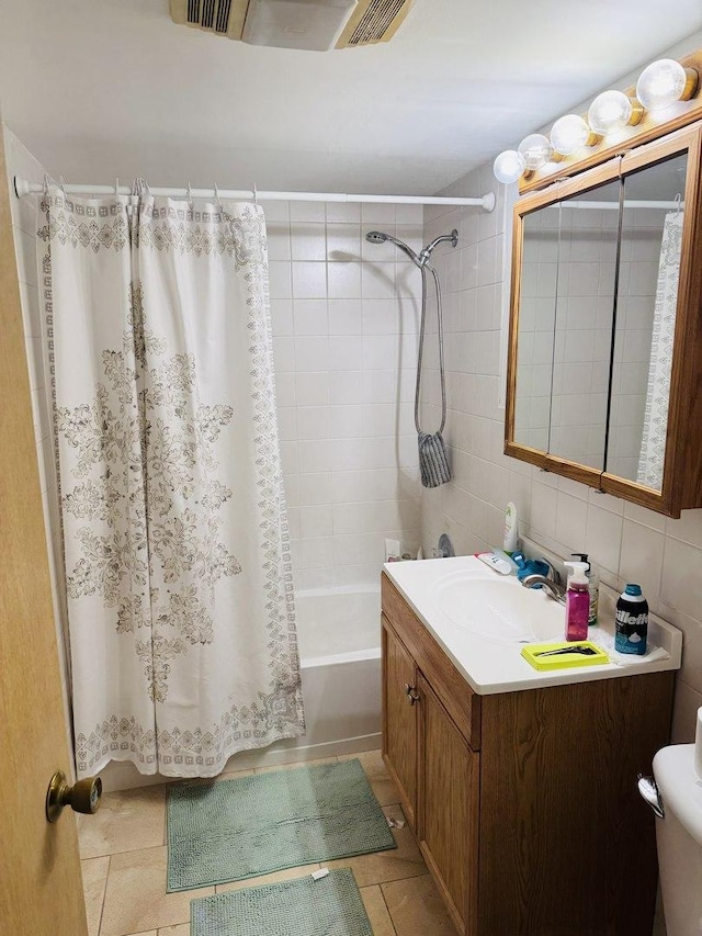 full bathroom featuring vanity, backsplash, tile patterned flooring, tile walls, and shower / tub combo