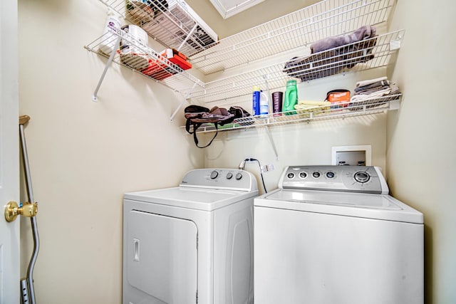 laundry room with washing machine and clothes dryer