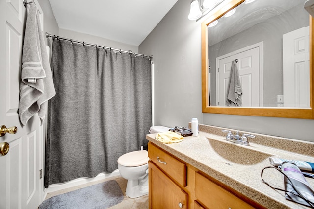 bathroom featuring tile patterned flooring, vanity, and toilet